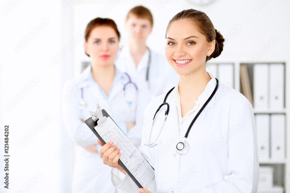 Happy doctor woman with medical staff at the hospital Happy doctor woman with medical staff at the hospital