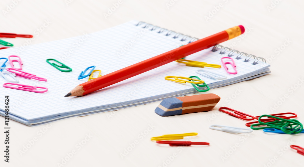 Notebook pencil paper clips on a desk Notebook pencil paper clips on a desk