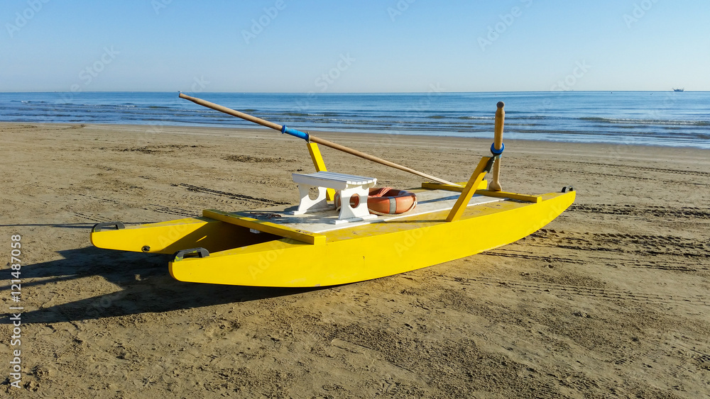 Yellow rescue boat on Italian beach. Adriatic sea. Yellow rescue boat on Italian beach. Adriatic sea.