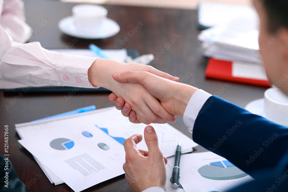 Business people shaking hands finishing up a meeting Business people shaking hands finishing up a meeting