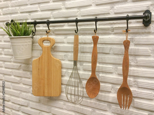Kitchenware hanging on brick wall.