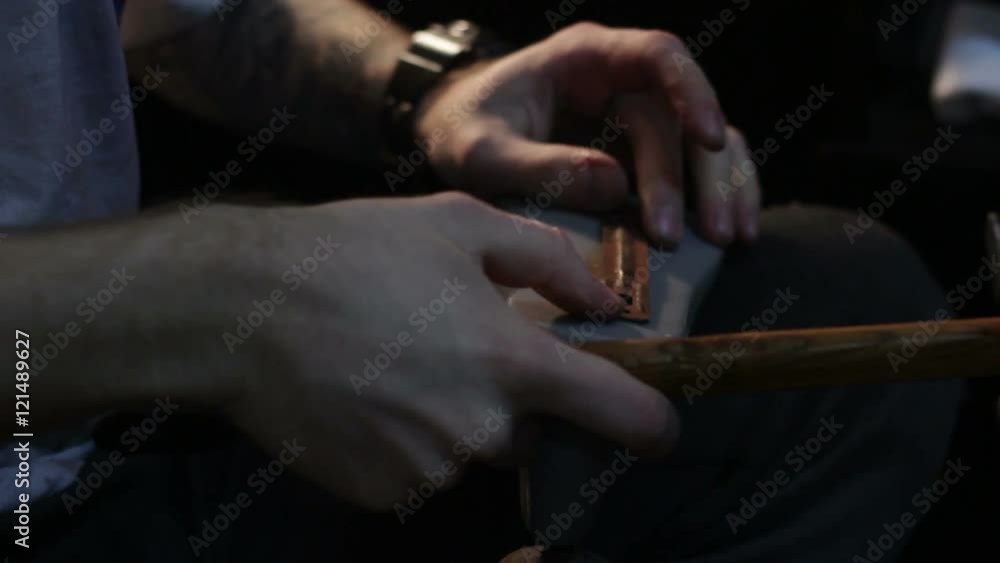 Shoemaker sews shoes, hammering sole Shoemaker sews shoes, hammering sole