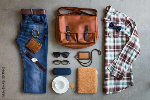 Flat lay of men's casual outfits with accessories on gray background
