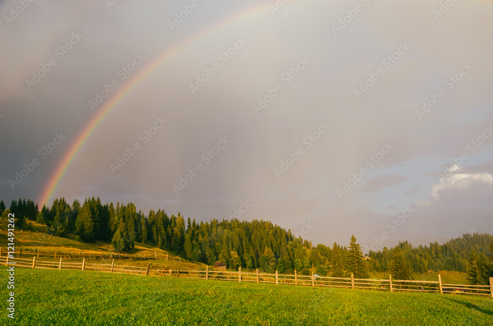 Rainbow in the mountain valley after rain. Beautiful landscape in Carpathians. Ukraine Rainbow in the mountain valley after rain. Beautiful landscape in Carpathians. Ukraine