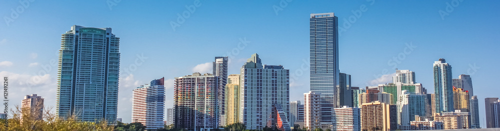 Panorama of Miami skyscrapers and skyline. Miami South Beach in Downtown District in sunny day. Apartment and business buildings in Miami Beach, Florida. Panorama of Miami skyscrapers and skyline. Miami South Beach in Downtown District in sunny day. Apartment and business buildings in Miami Beach, Florida.