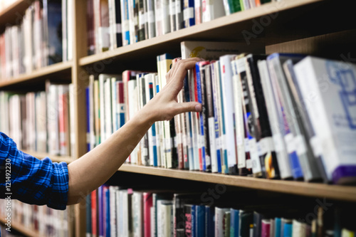 library, hand reaching for book