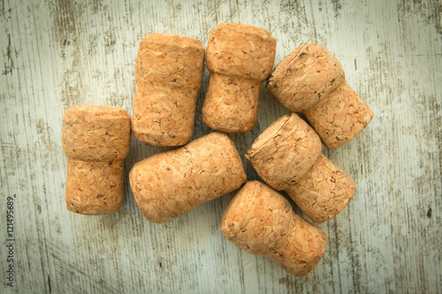 Corks from a champagne bottle on a wooden background