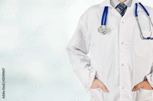 Doctor with hands in pocket on blurred background. Copyspace medical coneption