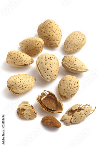 Almonds with kernels on white background