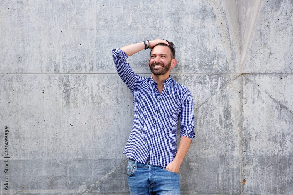Stylish mature man posing against wall Stylish mature man posing against wall