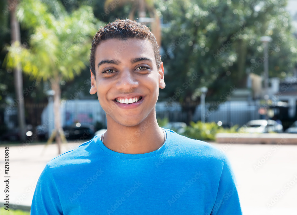 Laughing latin american guy with blue shirt Laughing latin american guy with blue shirt