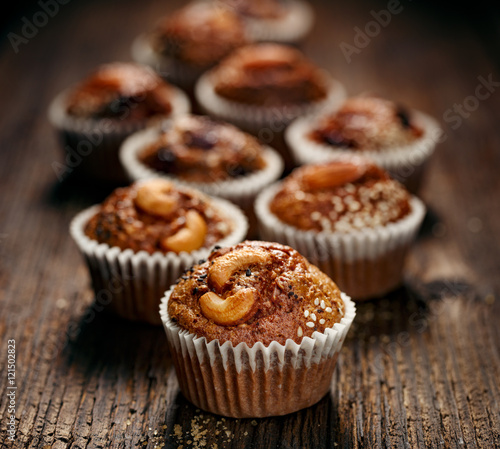 Nut chocolate muffins homemade on rustic wooden table