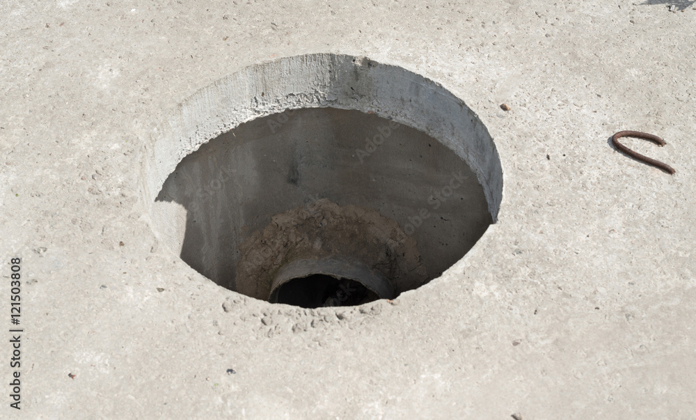 Manhole without cover in new concrete block