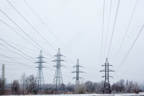 Electricity pylons and power lines in the winter day © rootstocks
