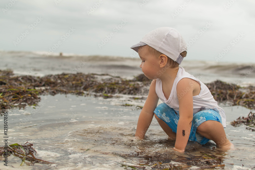 Kid on the beach near the ocean