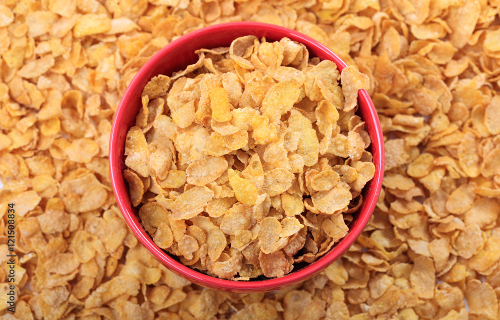 Bowl with corn flakes on corn flakes background Bowl with corn flakes on corn flakes background