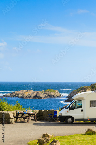 Camper car on coast of Norway with ocean view