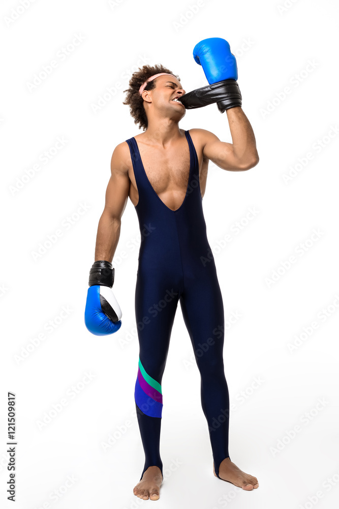African man trying take off boxing gloves over white background. African man trying take off boxing gloves over white background.