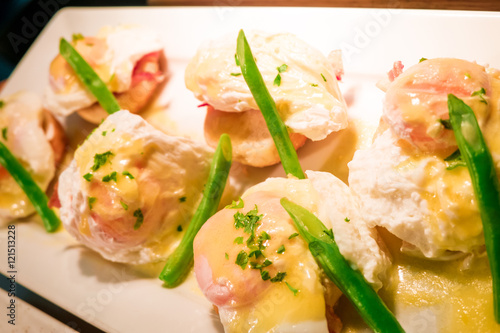 Eggs Benedict- toasted English muffins, ham, poached eggs aspara