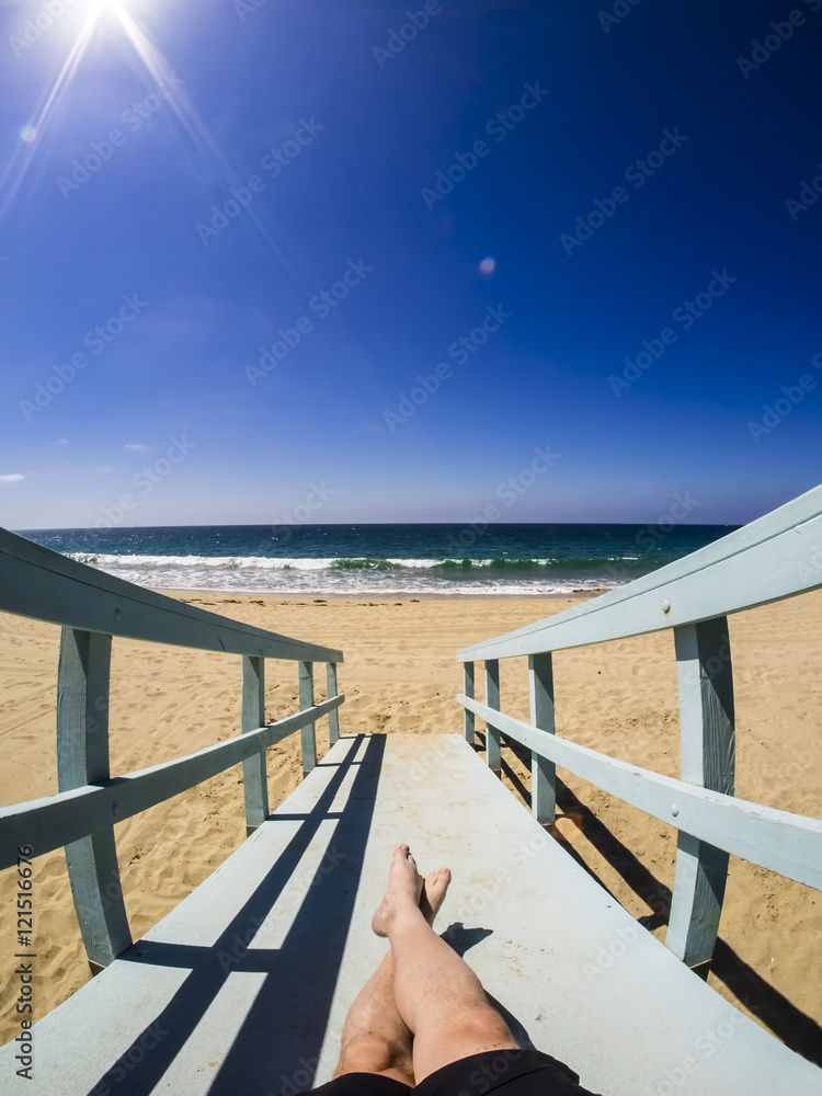 Lying on a rescue hut at beach in California Lying on a rescue hut at beach in California