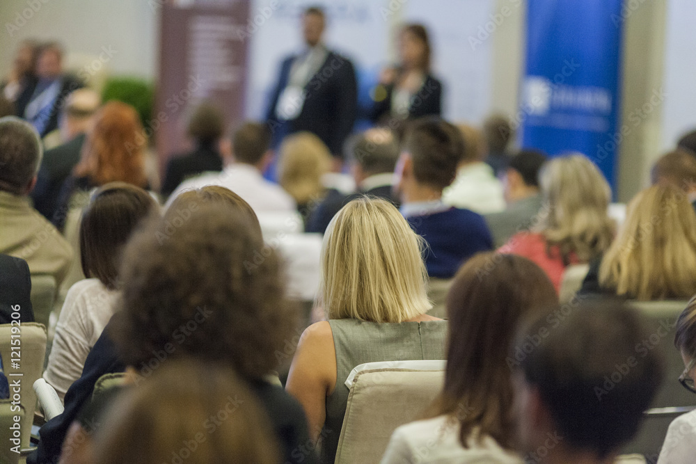 Obraz premium Host Speakers Standing in Front of the Audience During the Conference
