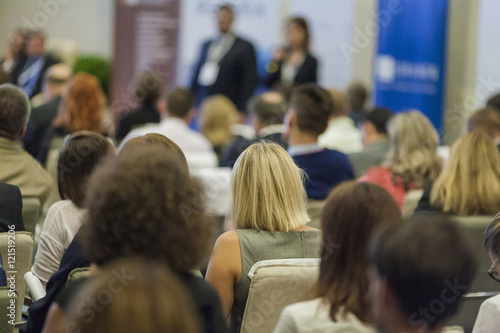 Host Speakers Standing in Front of the Audience During the Conference