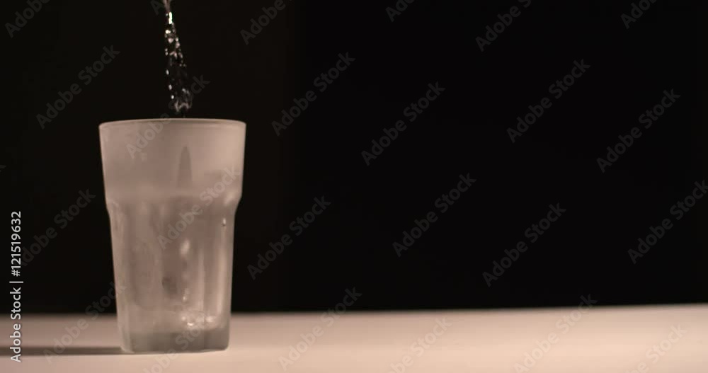 Clear liquid poured into Frosted glass-isolated background Clear liquid poured into Frosted glass-isolated background