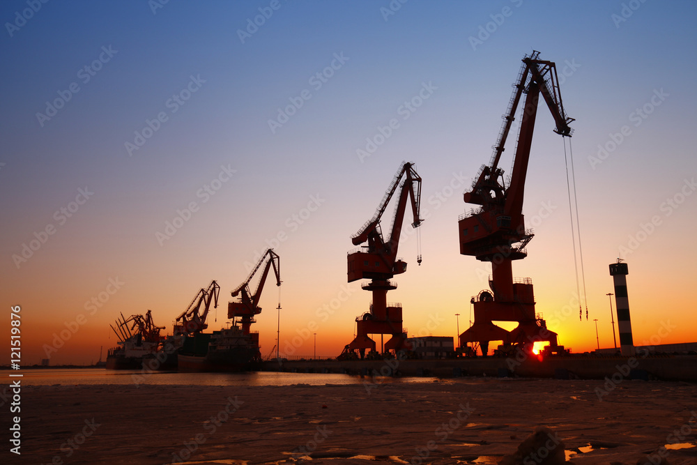 Port crane for work in the sunset Port crane for work in the sunset