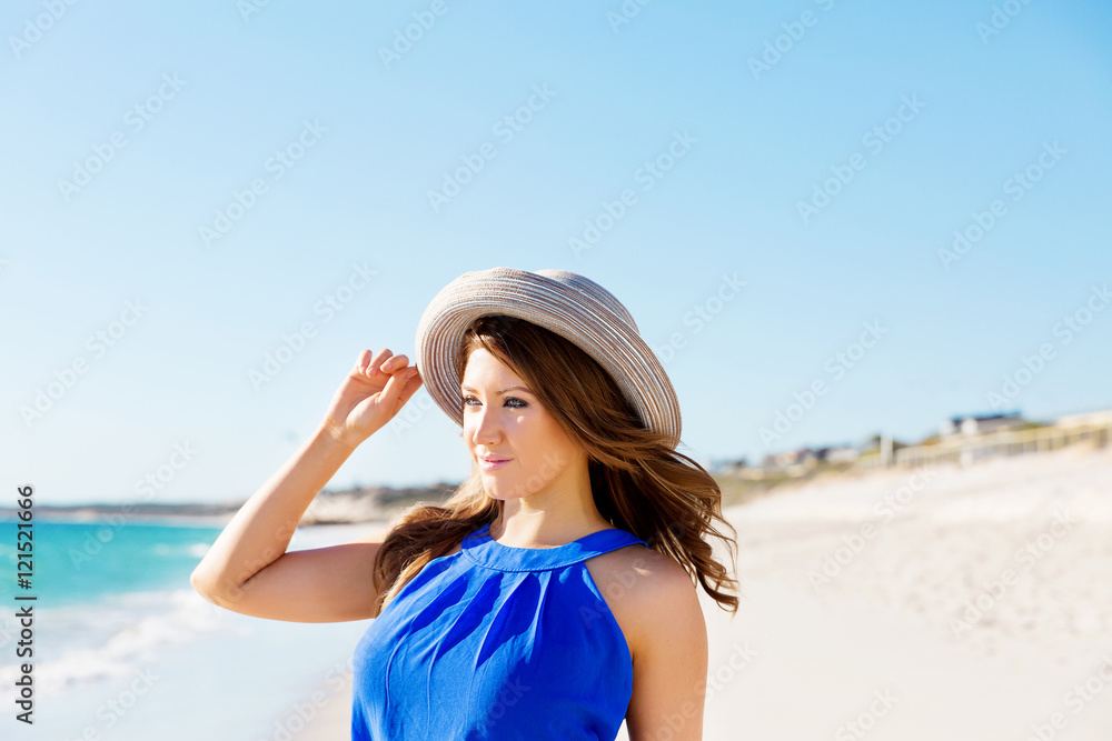 Young woman walking along the beach Young woman walking along the beach