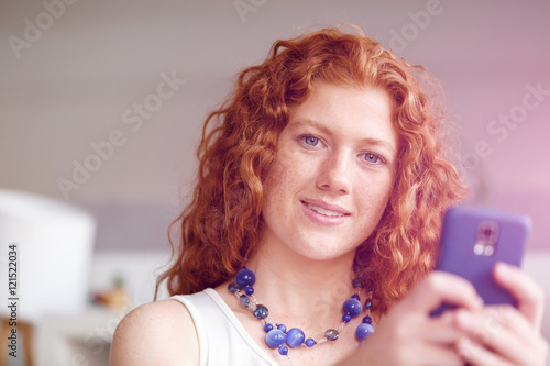 Happy beautiful young businesswoman using smart phone smiling