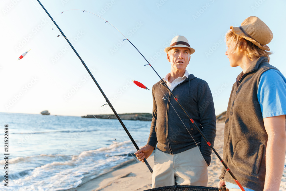 Senior man fishing with his grandson Senior man fishing with his grandson