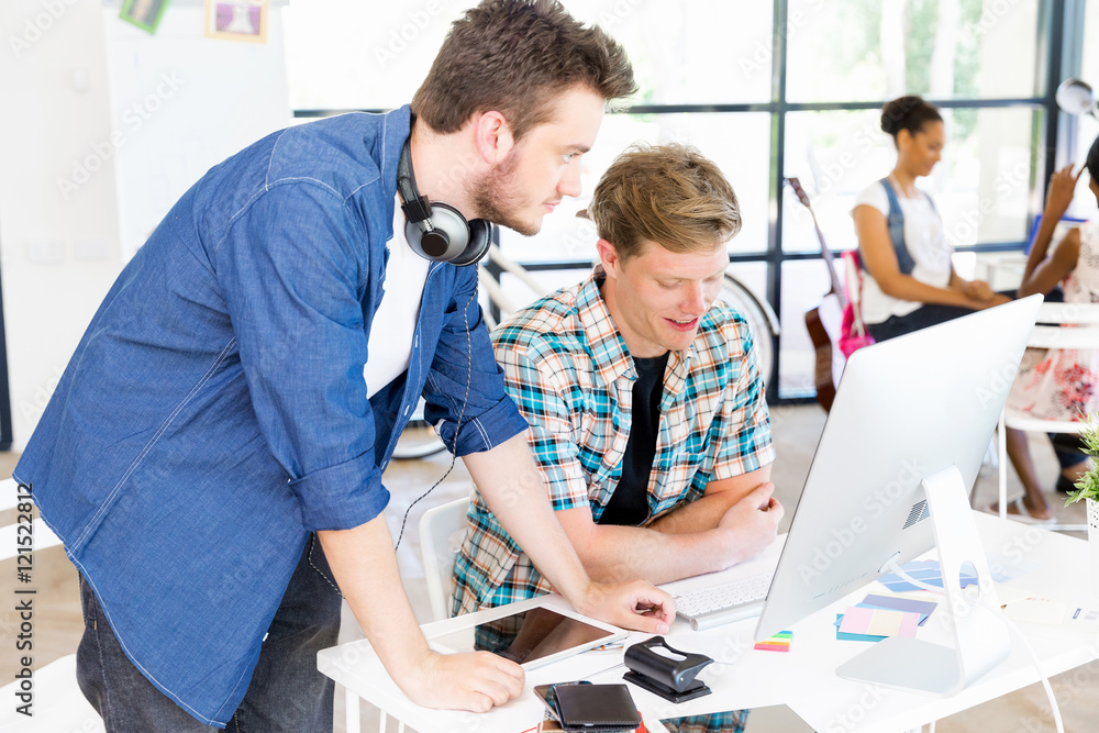 Fototapeta premium Young office workers discussing