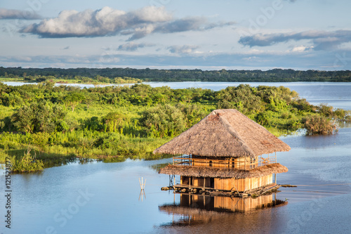 FLOATING HOUSE ON THE AMAZON RIVER. photo