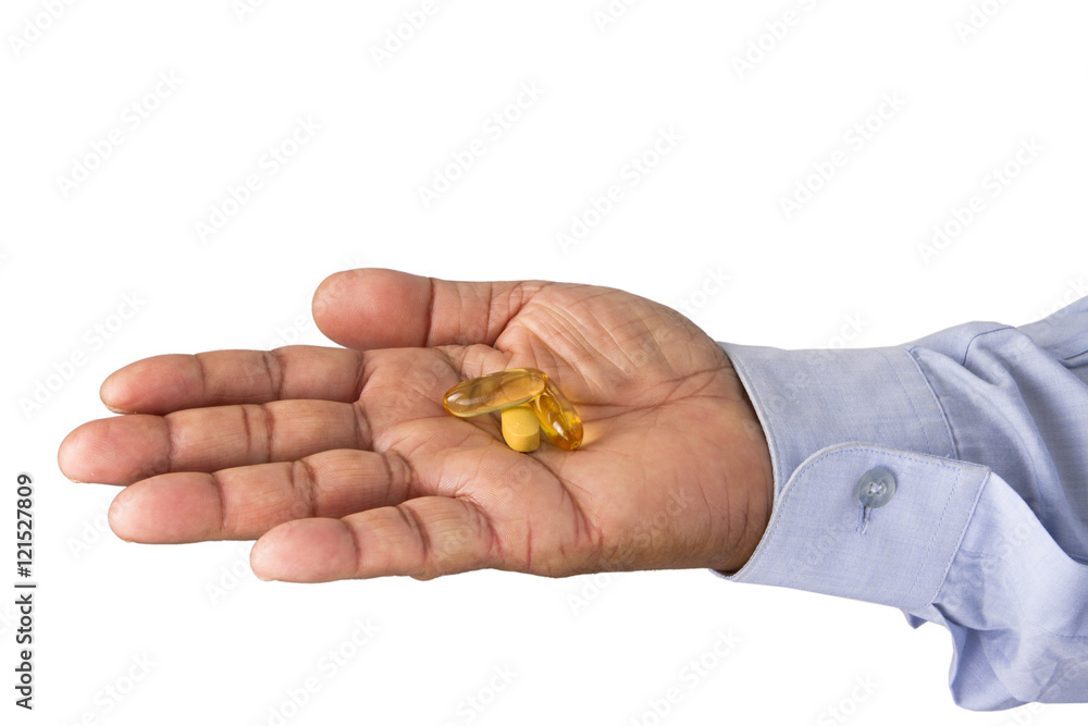 Holding medicine pills like fish oil tablets and vitamin tablet Holding medicine pills like fish oil tablets and vitamin tablet