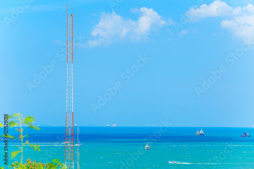 Communications tower with sea or ocean in the background.