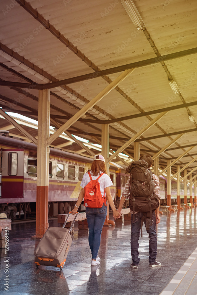 boy and girl with luggage at station traveling by train boy and girl with luggage at station traveling by train
