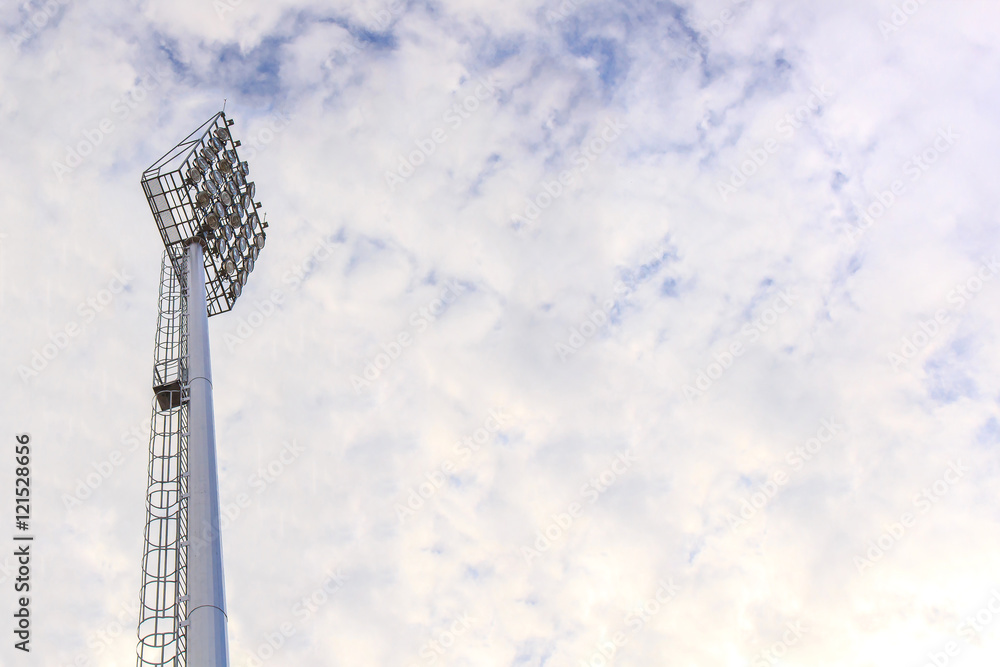 Obraz premium Lighting tower of stadium on sky and cloud background.