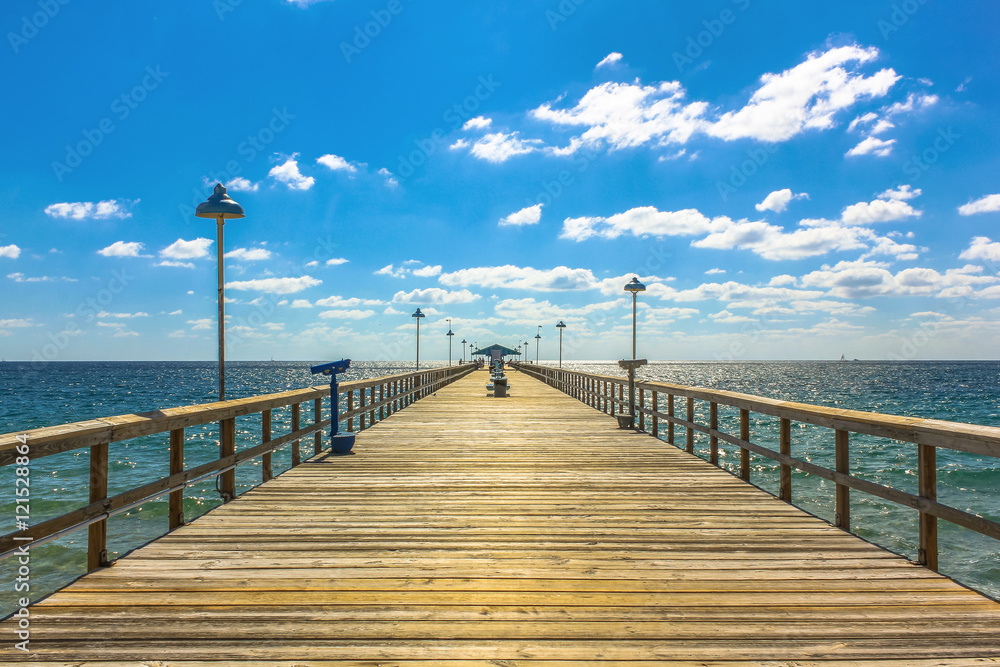 Spectacular perspective view of the famous Anglins Fishing Pier in a sunny day with blue sky, Lauderdale by the Sea, 30 miles from Miami, Florida, United States.