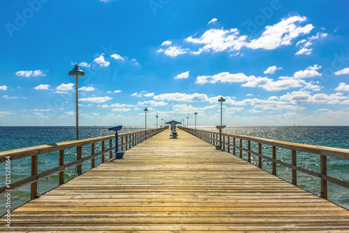 Spectacular perspective view of the famous Anglins Fishing Pier in a sunny day with blue sky, Lauderdale by the Sea, 30 miles from Miami, Florida, United States. photo