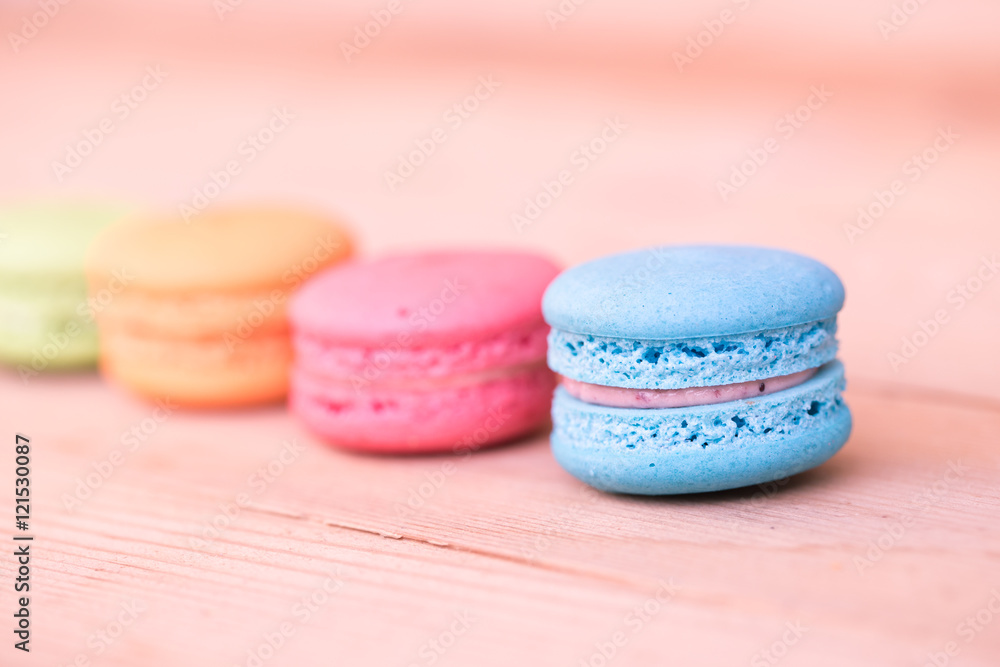 Fototapeta premium macarons sweet beauty dessert on wood background pink color tone.