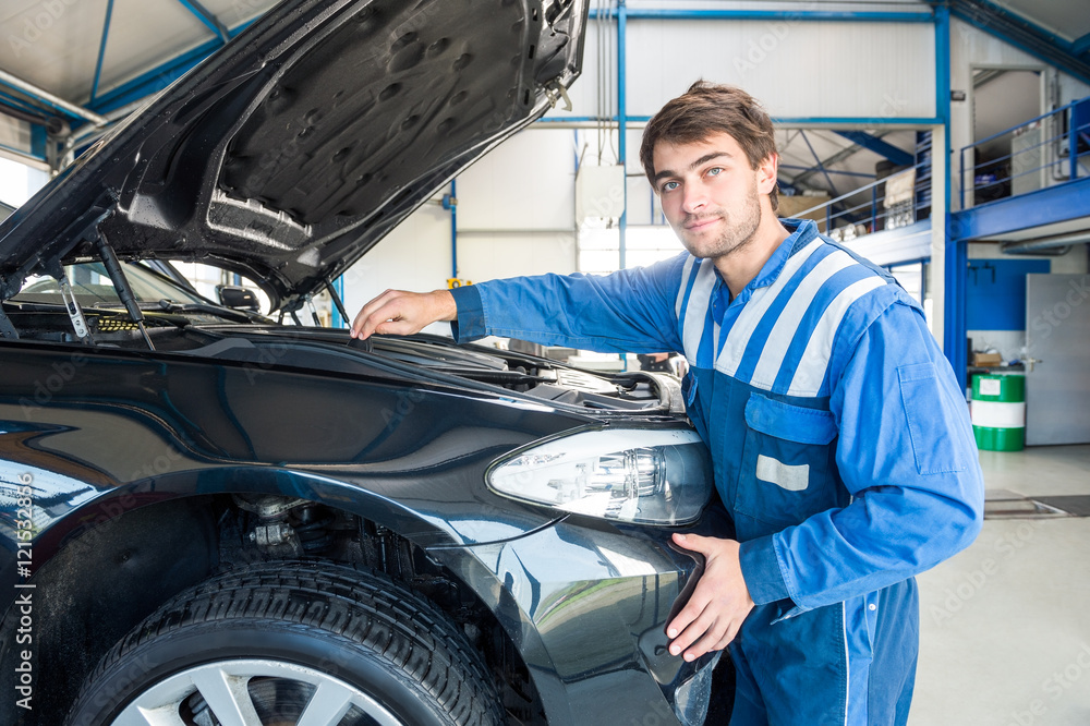 Mechanic Repairing Car Engine In Garage Mechanic Repairing Car Engine In Garage