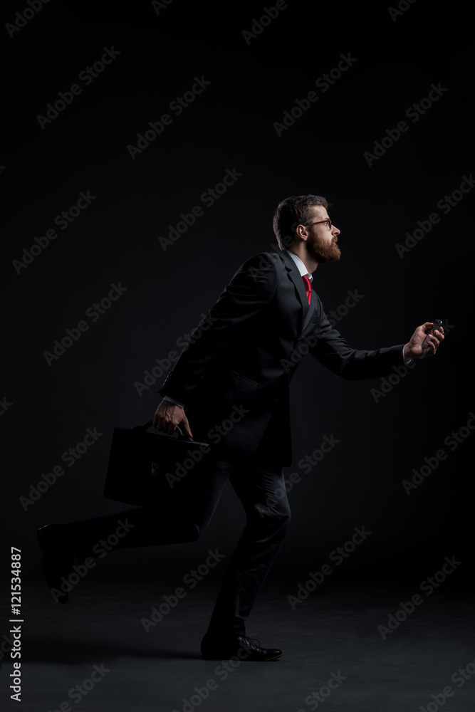 Businessman running hurry on a black background Businessman running hurry on a black background