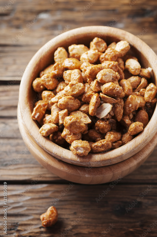 Sugared peanuts on the wooden background Sugared peanuts on the wooden background