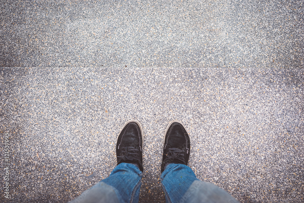 Looking down on feet on a surface, space for text. selective focus