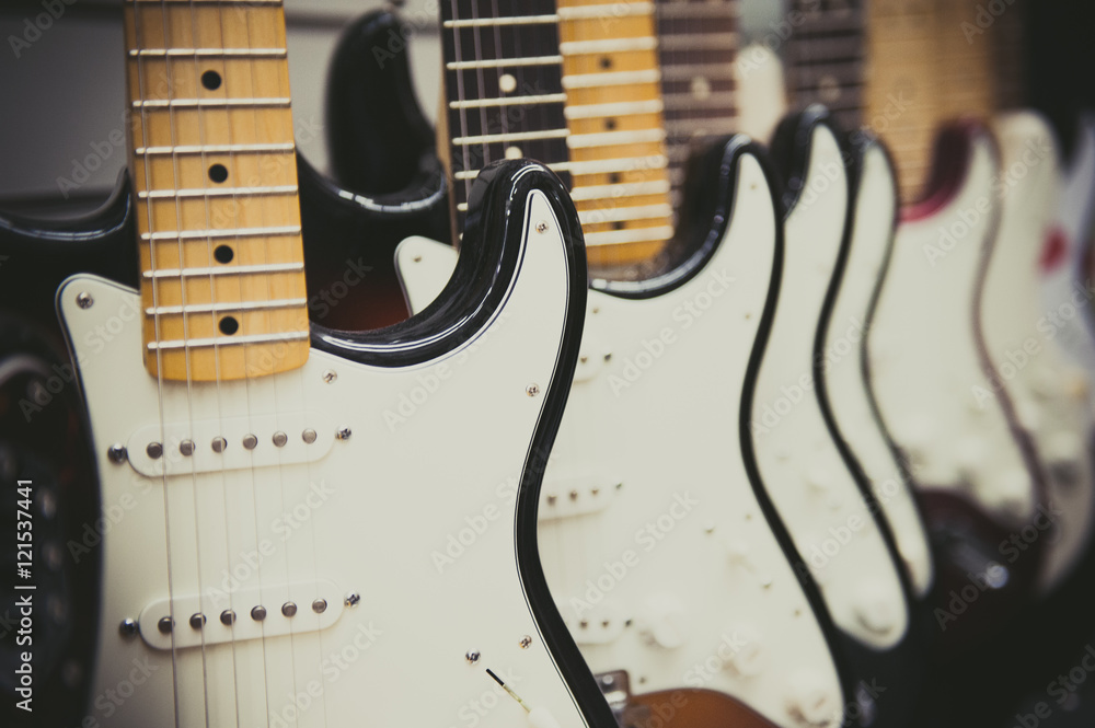 Fototapeta premium Many electric guitars body aligned in the store
