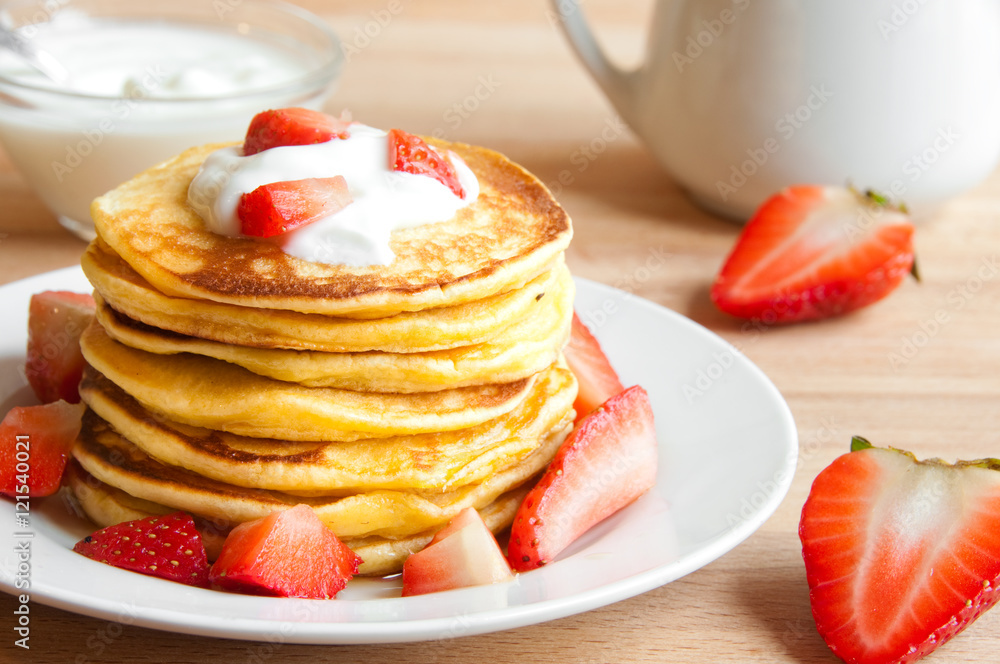 Pancekes with sour cream and strawberries for breakfast Pancekes with sour cream and strawberries for breakfast