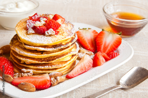 Pancakes with maple syrop and strawberries fro breakfast