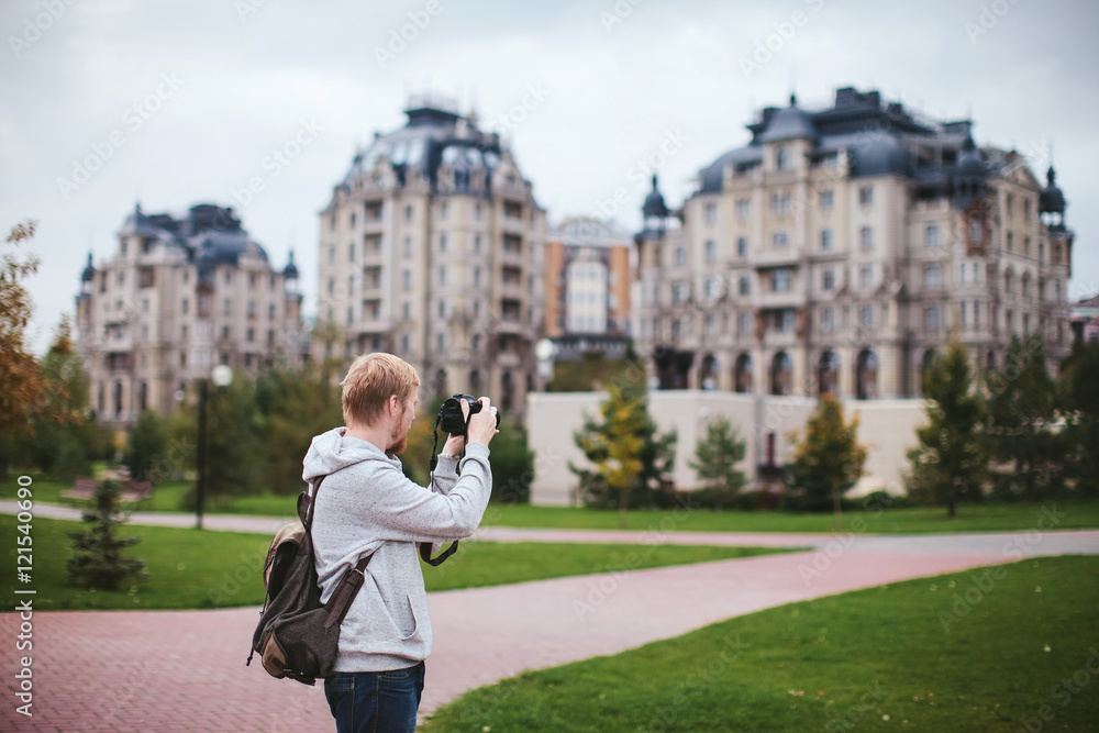 bearded man photographs the city