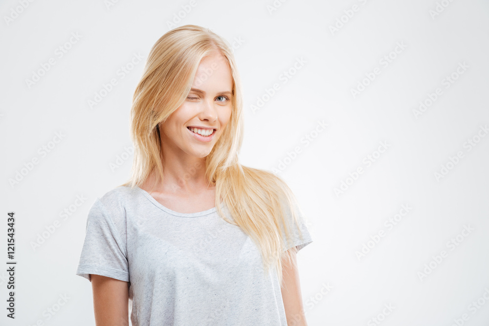 Happy attractive casual girl standing and winking Happy attractive casual girl standing and winking