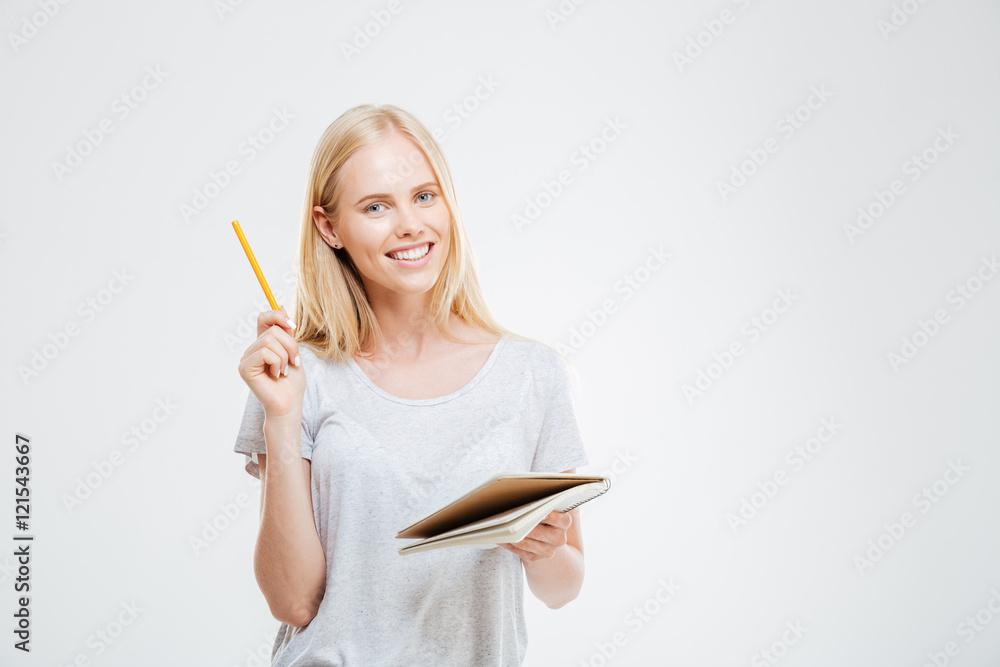 Cheerful young pretty girl holding notebook with idea Cheerful young pretty girl holding notebook with idea